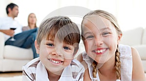 Smiling siblings lying on the floor photo