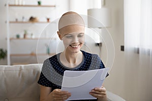 Smiling sick woman with cancer read good results in letter