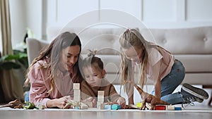 Smiling single mother enjoying playtime with two small children.