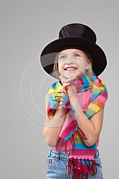 Smiling six year old girl in a black hat