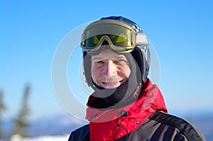 Smiling skier in helmet