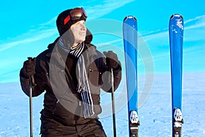 Smiling skier man at mountain landscape