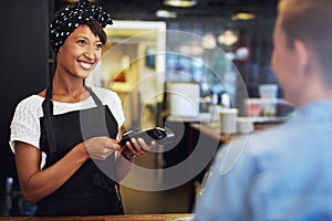 Smiling small business owner taking payment