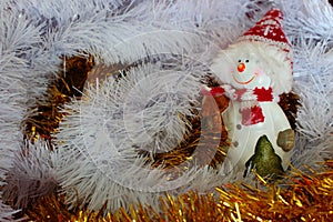 Smiling snowman figure in white and yellow festive decoration as winter holidays decoration and mood.