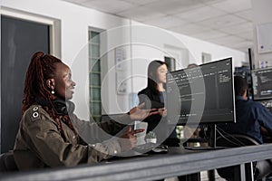 Smiling software developer programming server code algorithm on computer