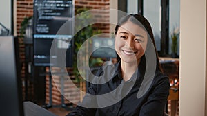 Smiling software developer typing machine learning app code on computer keyboard