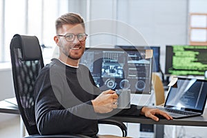 Smiling Software Programmer at Workplace