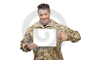 Smiling soldier pointing at placard