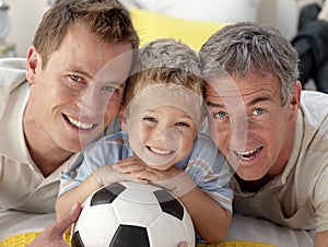 Smiling son, father and grandfather on floor