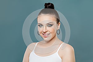 Smiling spa model woman with clear healthy skin on blue, portrait