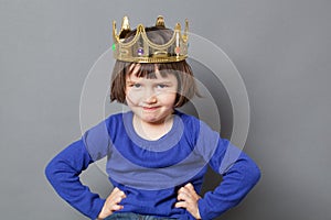 Smiling spoiled kid with golden crown on photo