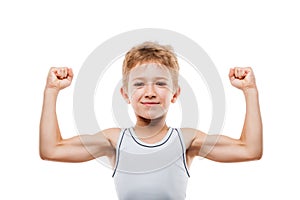 Smiling sport child boy showing his hand biceps muscles strength