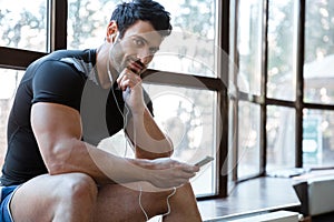 Smiling sportsman listening to music