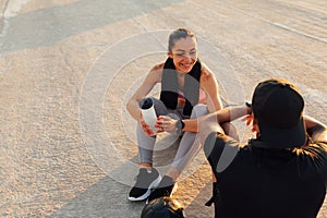 Smiling sportswoman looking at her fitness buddy