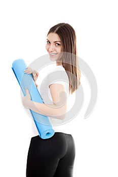 Smiling sporty girl with yoga mat