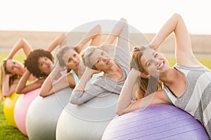 Smiling sporty women working out with exercise balls