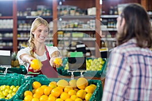 Smiling staff assisting a man with grocery shopping