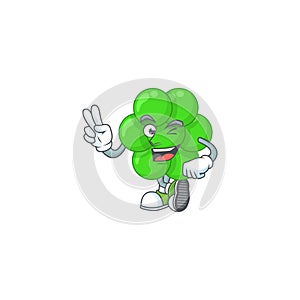 Smiling staphylococcus aureus cartoon mascot style with two fingers