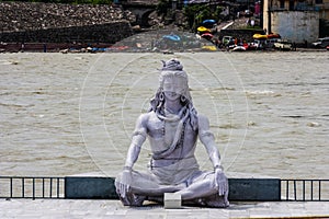 Smiling statue of shiva on the banks of the Ganges in Rishikesh