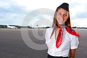 Smiling stewardess on the airfield
