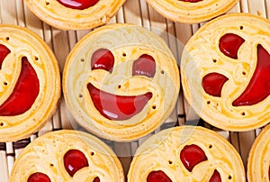 Smiling strawberry jam cookies. Close up