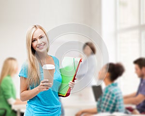 Smiling student with folders