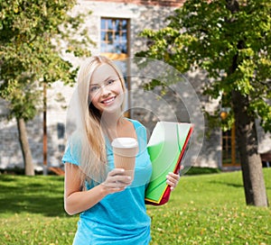 Smiling student with folders