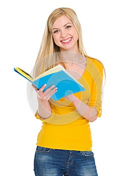 Smiling student girl reading book