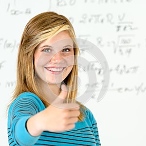 Smiling student girl thumb up mathematics board