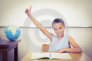 Smiling student with a rasied hand