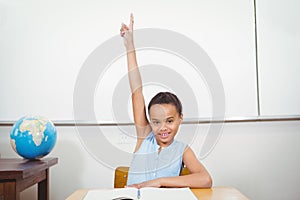 Smiling student with a rasied hand