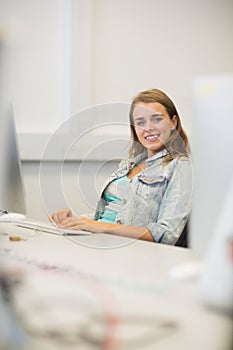 Smiling student studying in the computer room