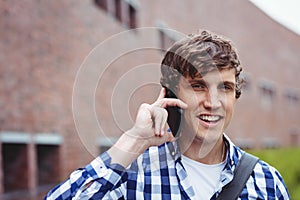 Smiling student talking on mobile phone