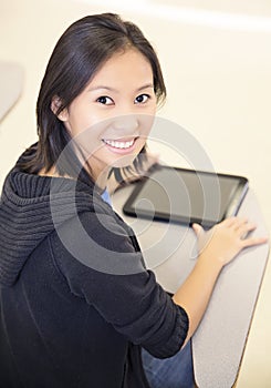 Smiling student using a tablet computer