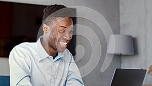 Smiling student writing typing on laptop keyboard