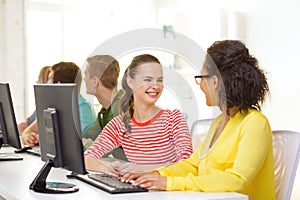 Smiling students in computer class at school