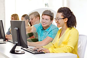 Smiling students in computer class at school