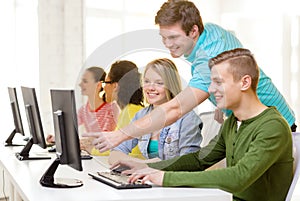 Smiling students in computer class at school