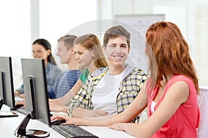 Smiling students in computer class at school