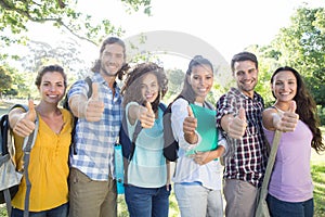 Smiling students showing thumbs up