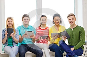 Smiling students with tablet pc computer