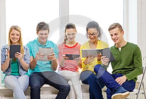 Smiling students with tablet pc computer