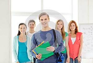 Smiling students with teenage boy in front