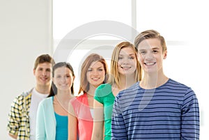 Smiling students with teenage boy in front