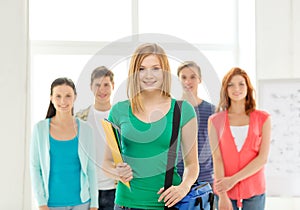 Smiling students with teenage girl in front