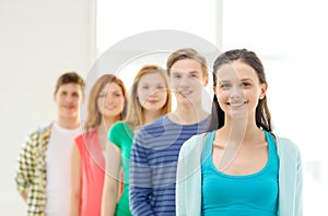 Smiling students with teenage girl in front