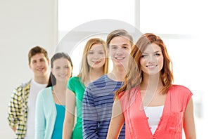 Smiling students with teenage girl in front