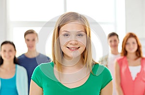 Smiling students with teenage girl in front