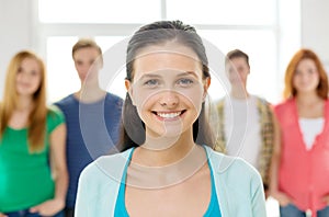 Smiling students with teenage girl in front