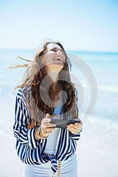 smiling stylish 40 years old woman on seacoast